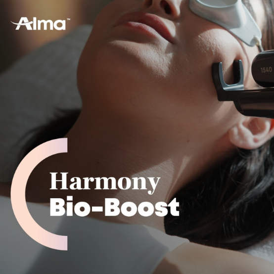 Woman receiving a facial laser treatment while wearing protective goggles, with the text 'Harmony Bio-Boost' and Alma logo.