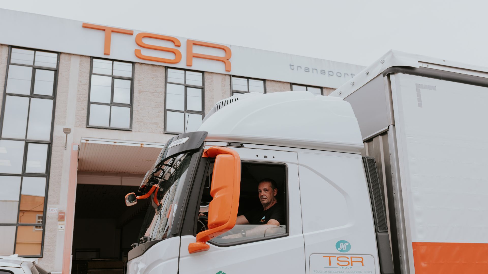 Conductor de TSR Group al volante de camión en la sede de Bergondo, preparado para ruta nacional o internacional