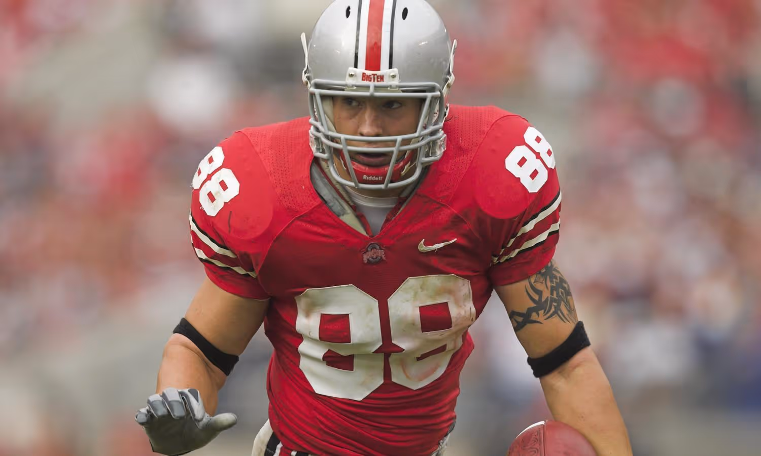 Rory Nicol Ohio State football player wearing a red jersey number 88 and silver helmet running with the ball.