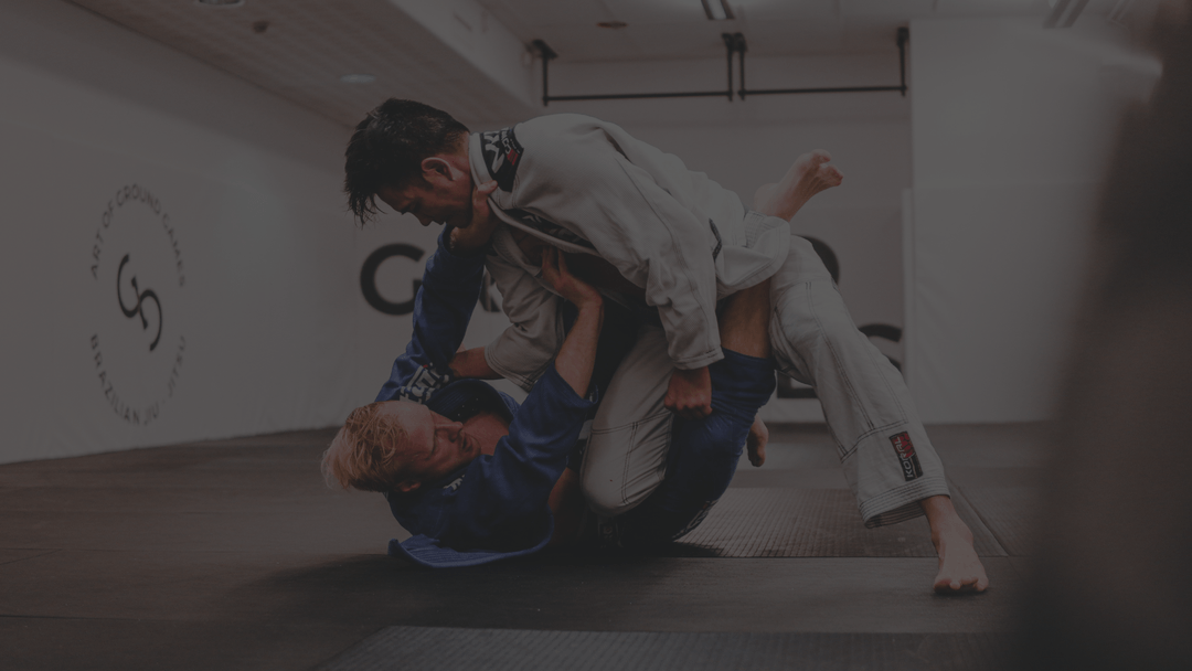 Two AOGG members training gi jiu-jitsu on the mat