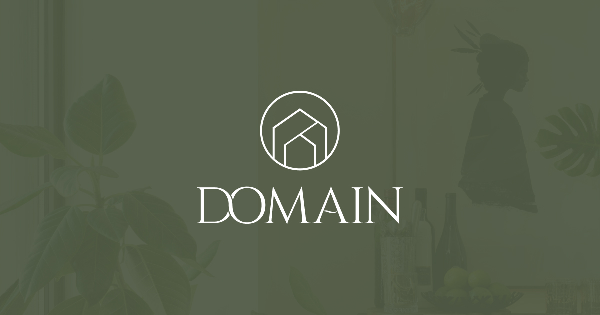 Domain logo with stylized house icon above the text on a greenish background.