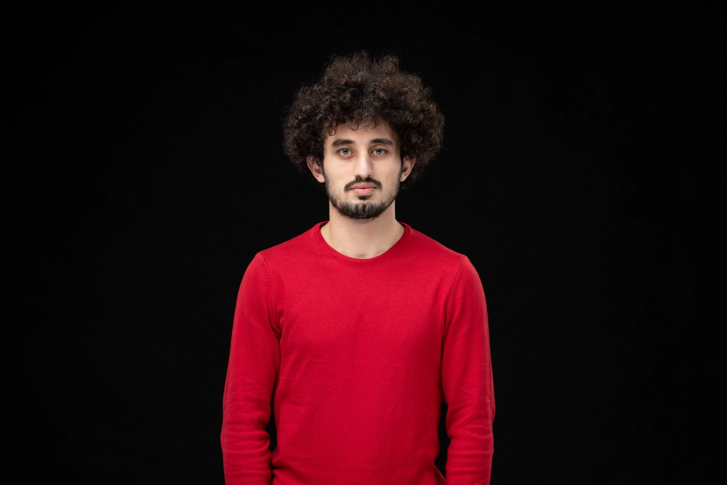 A man infront a gray background