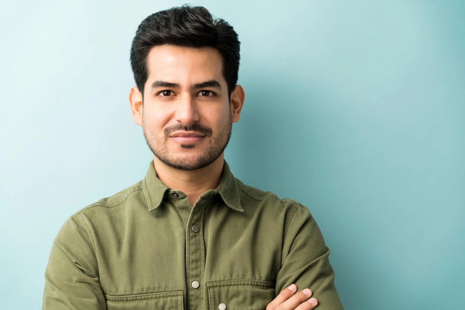 A man infront a gray background