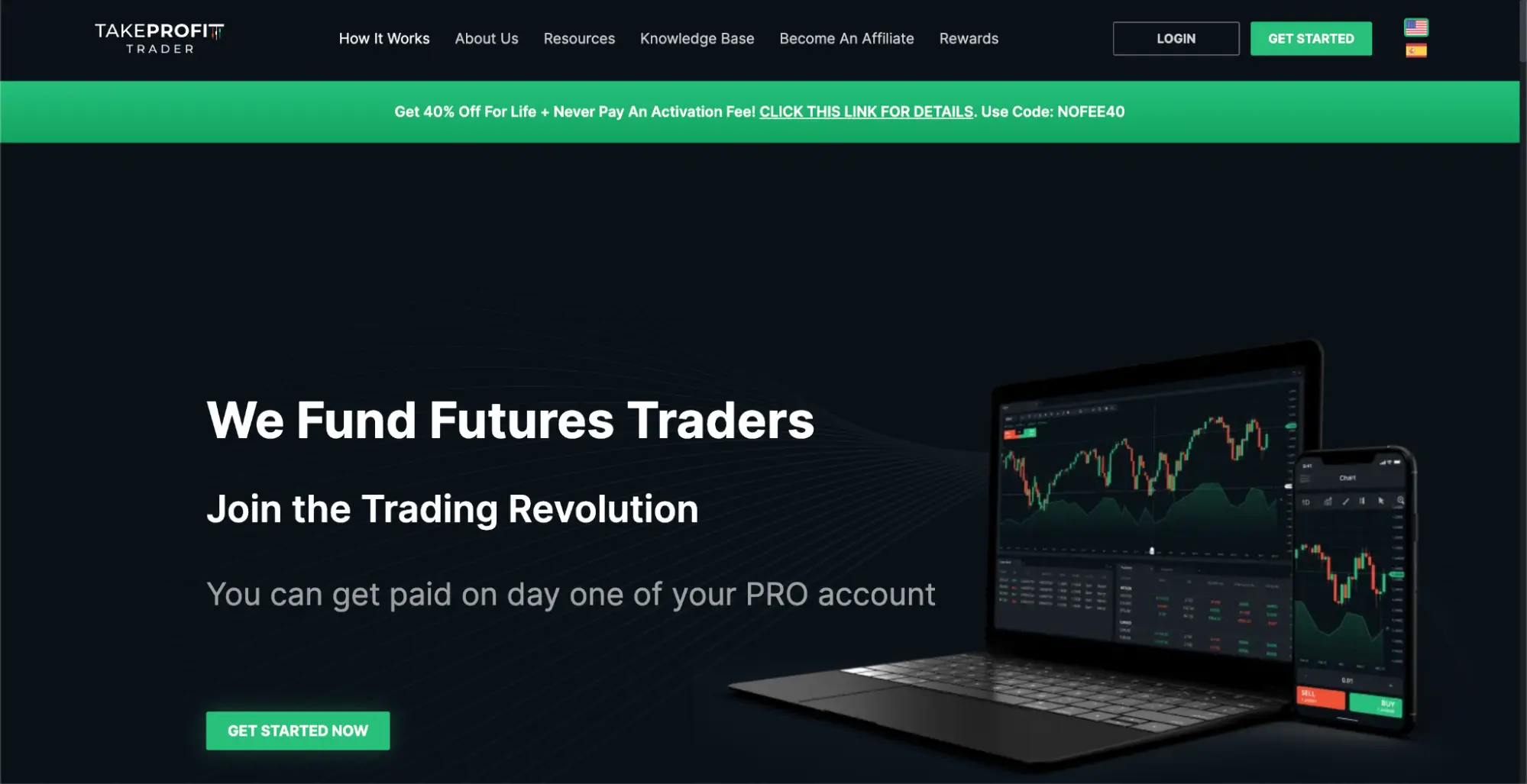 Take Profit Trader’s homepage with the hero “We fund futures traders” with a laptop and smartphone with trading graphs to the right.