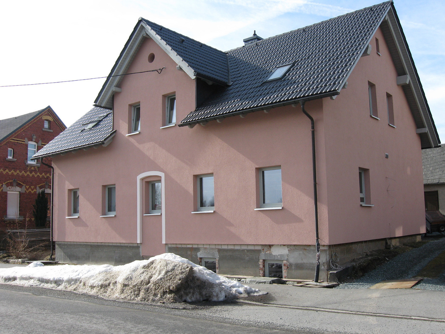Großes Mehrfamilienhaus nach der energetischen Sanierung. Durch den Vollwärmeschutz werden hier nun Heizkosten gespart.