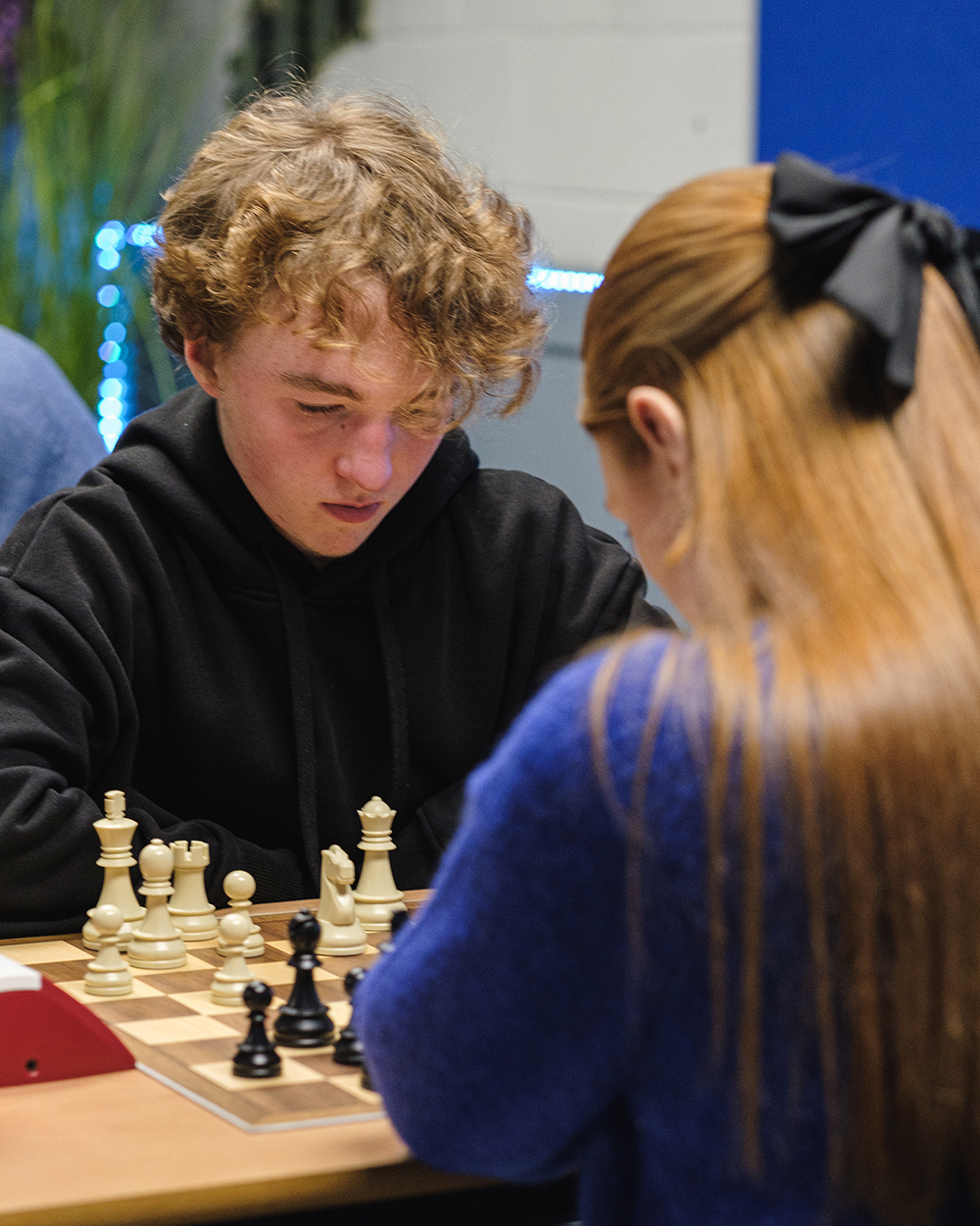 Two chess club members play a game at a rapid tournament.