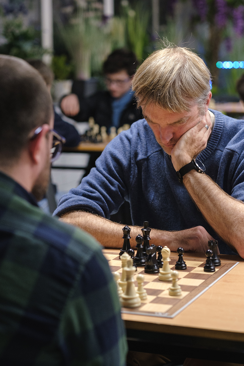 Two KoE Chess Club members play chess at a rapid tournament. 