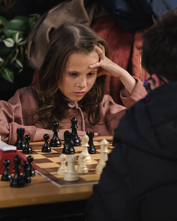 KoE chess club member plays chess.