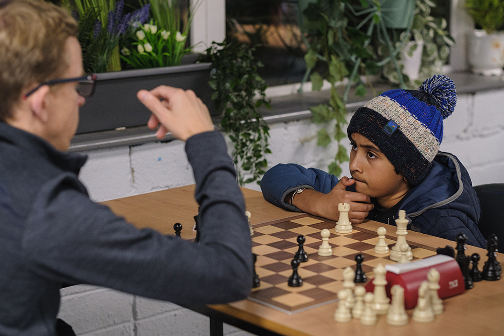 Two members of the club play chess together
