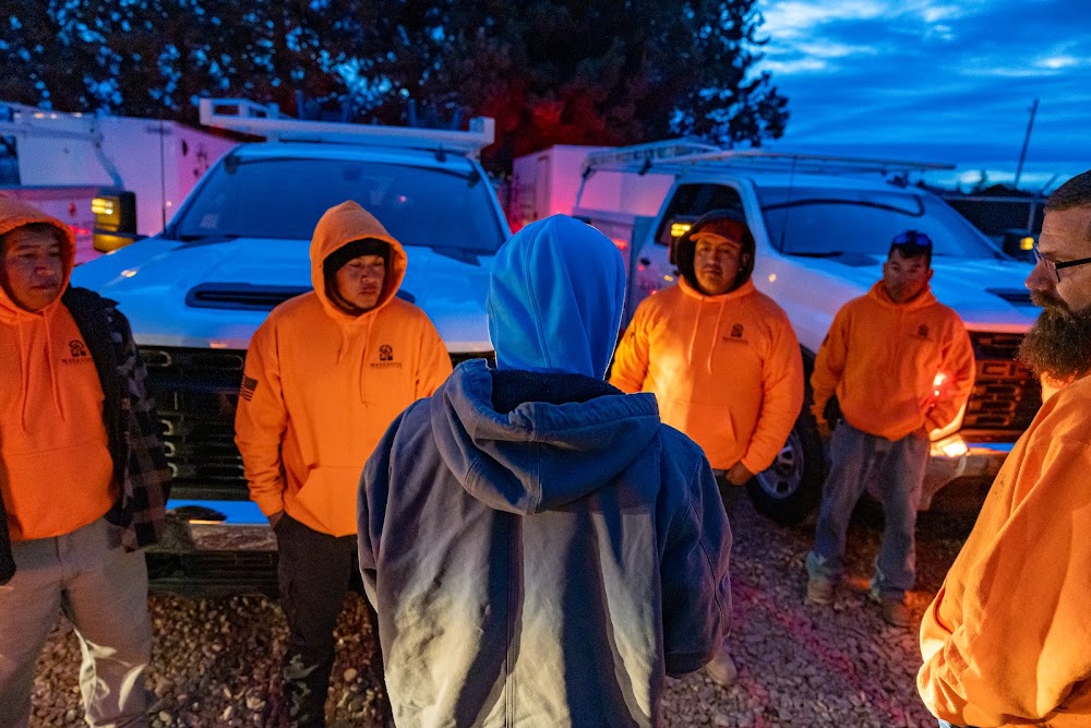 Landscaping crew gathering for a morning huddle before the workday