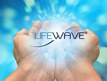 Boy sitting in a chair with closed eyes wearing hearing test earphones connected by wires.