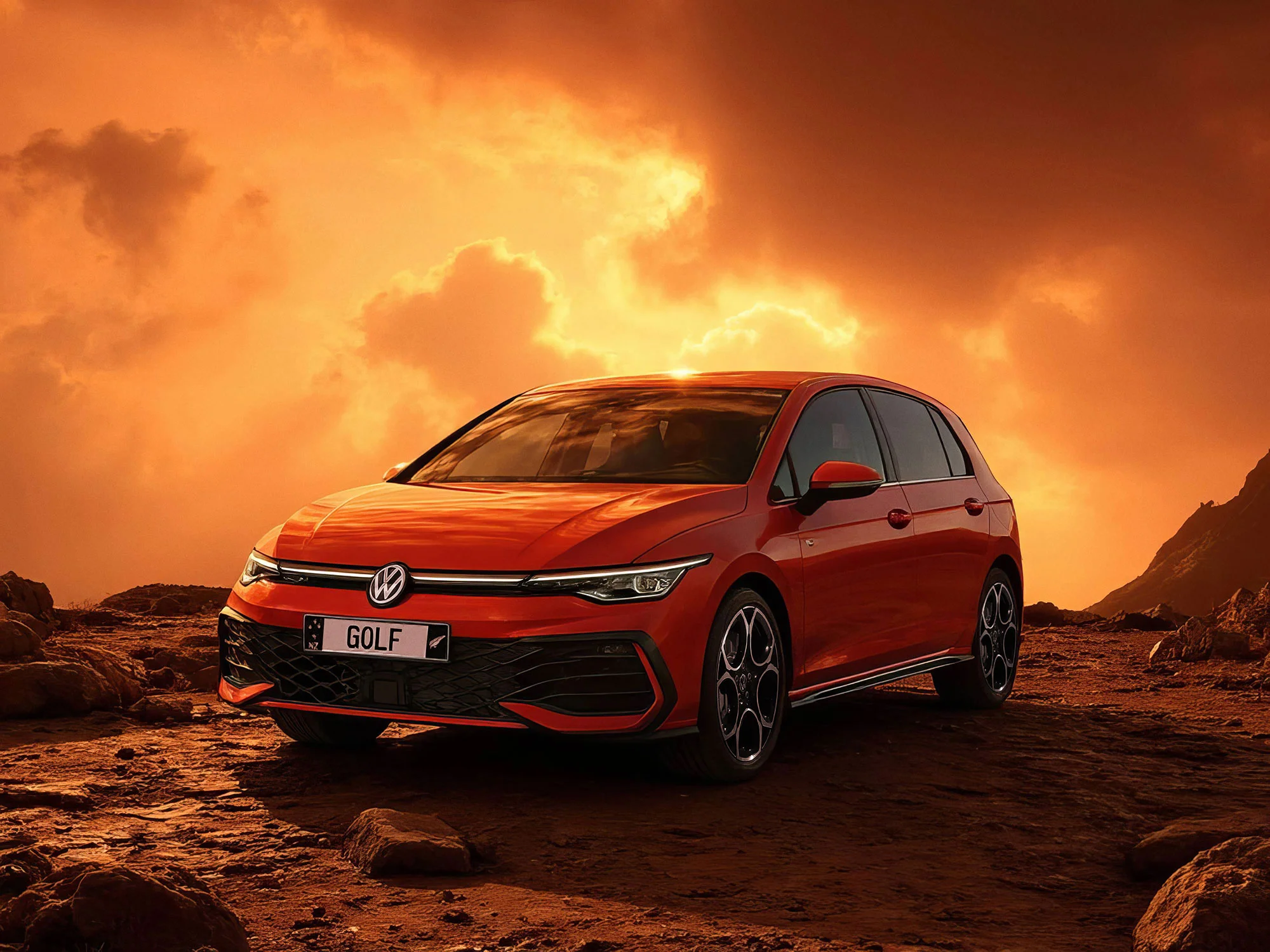 Red Volkswagen Golf parked on rocky terrain under dramatic orange sky with clouds.
