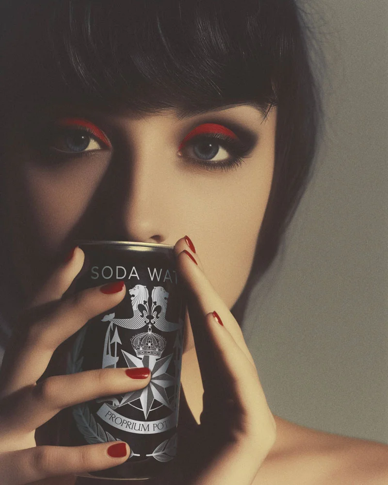 Woman with dark hair and red eyeshadow holding a black soda water can near her face, with matching red nail polish.