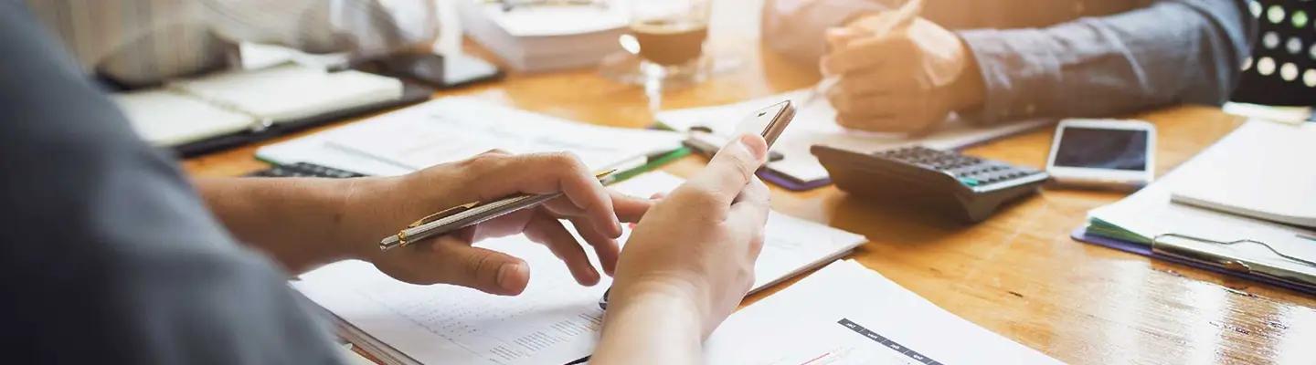 Image of people working in a group on a table.