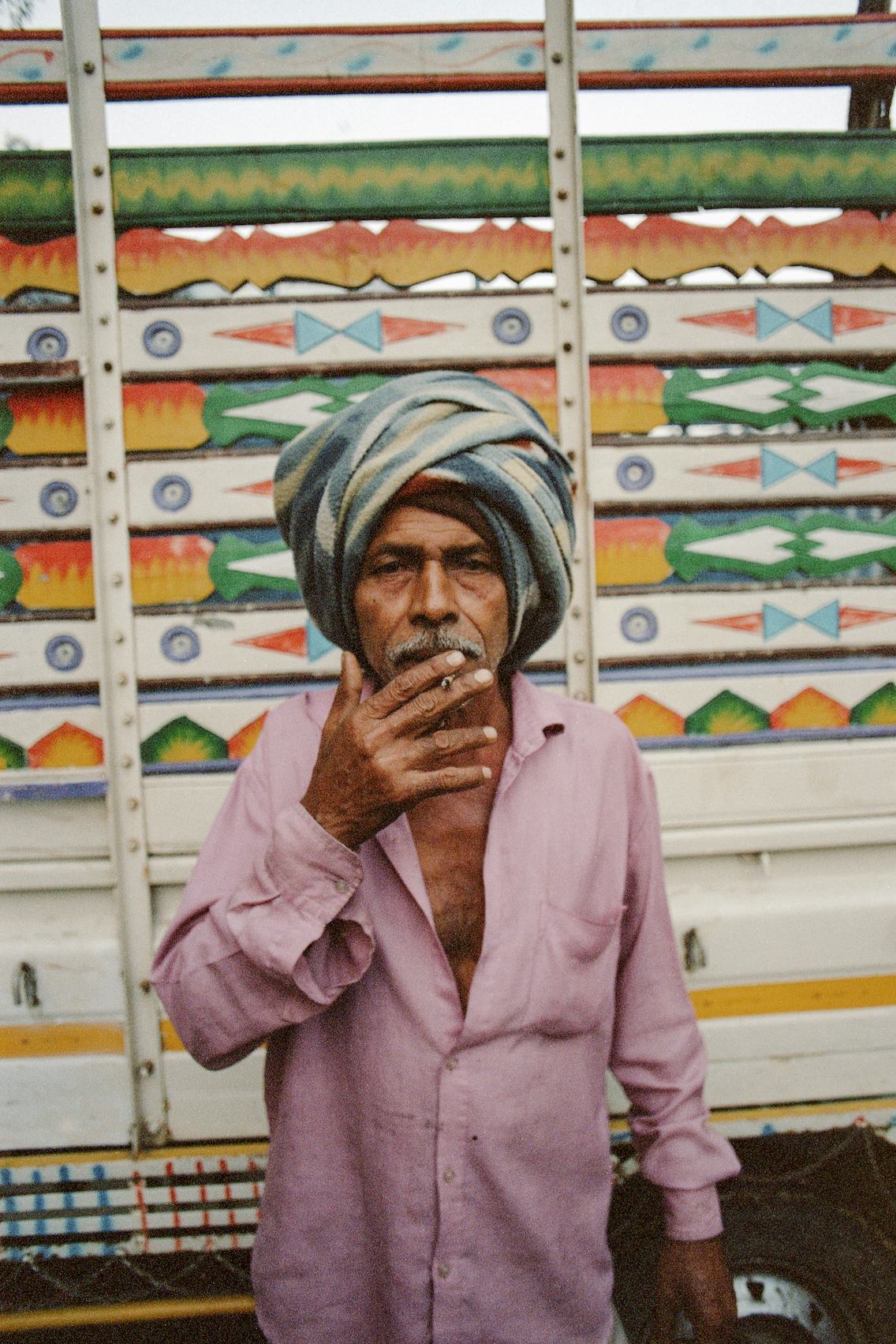 Three young men in red blazers standing in the desert.