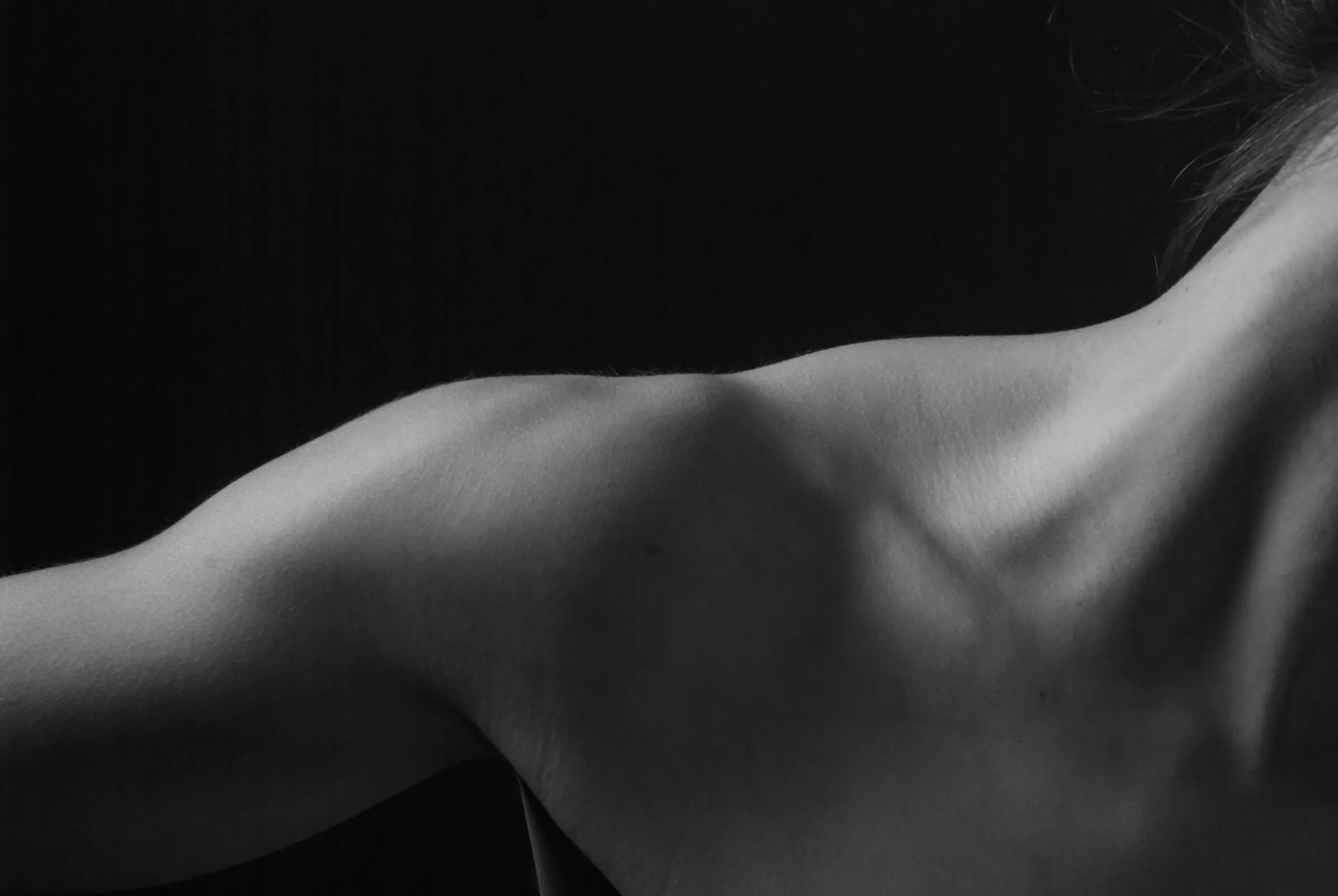 Black and white close-up of a patient's shoulder and upper back
