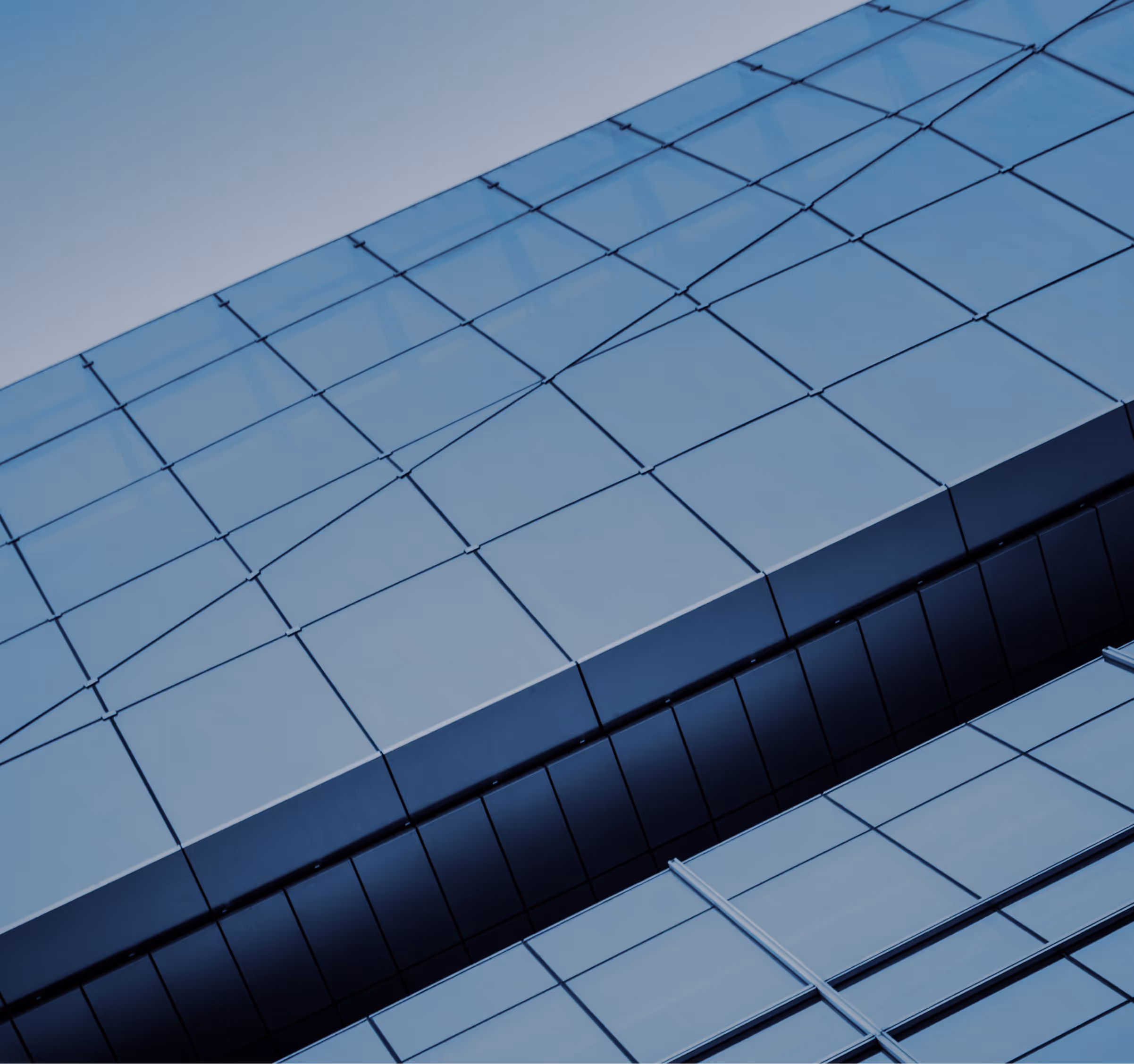 Close-up view of a modern building facade with reflective blue glass panels and clean geometric lines.