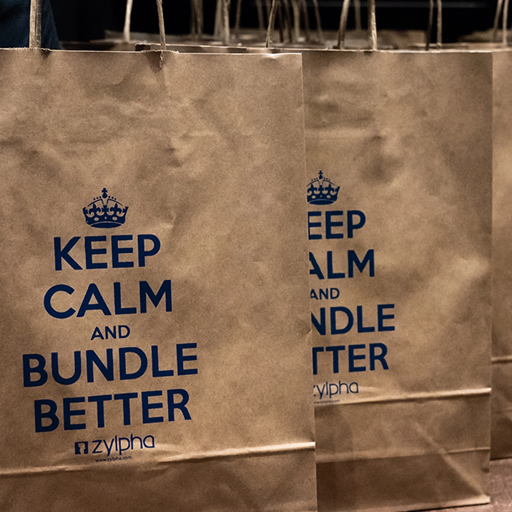A brown paper bag with 'keep calm and bundle better' written on it from a Zylpha product event