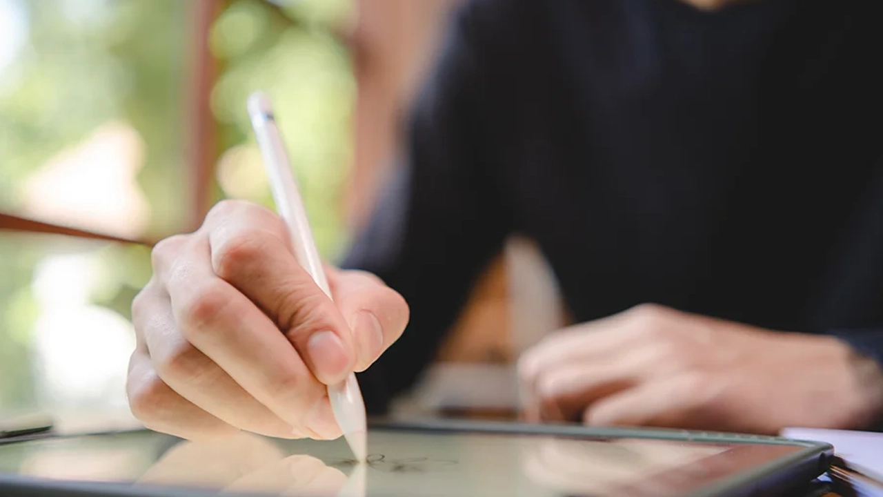 man signing on a tablet