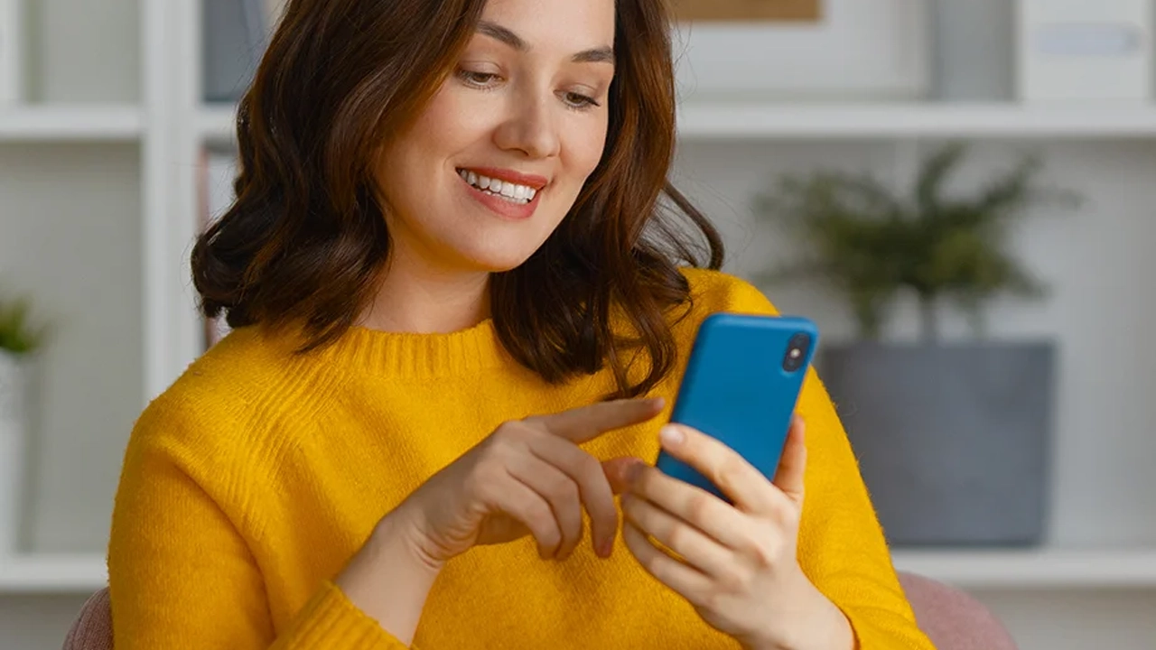 Young woman using MFA on her phone to login to Zylpha