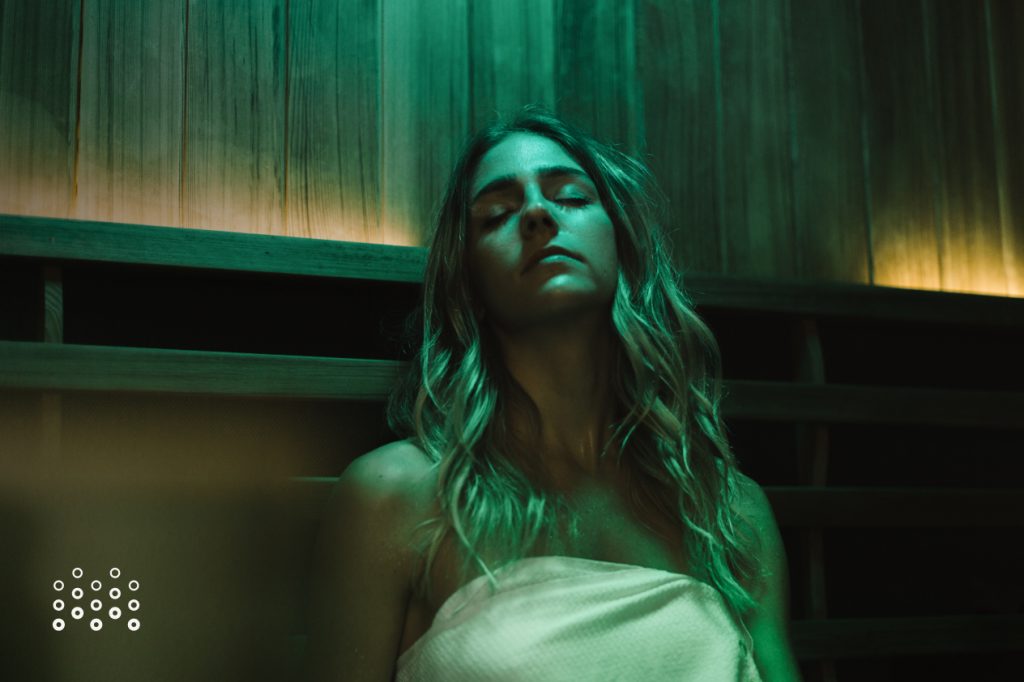Woman relaxing in infrared sauna