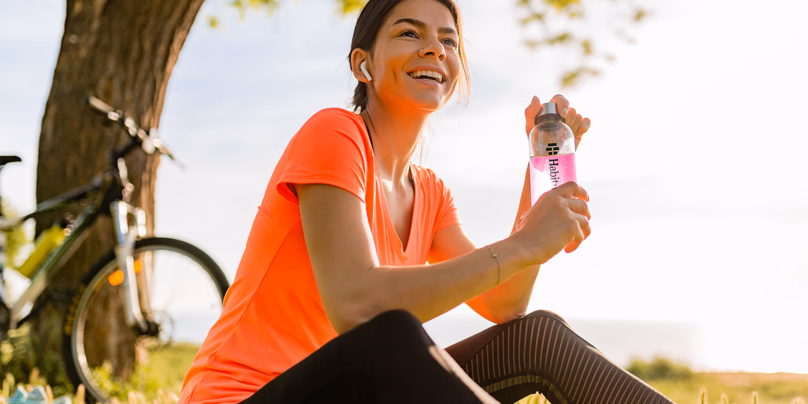 Woman holding Habitual bottle with electrolytes