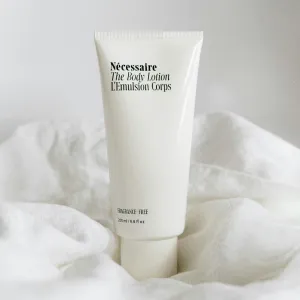 white tube of body lotion sitting in white sheets
