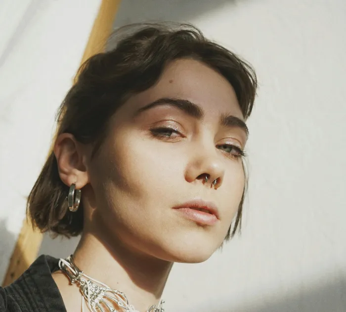 woman with nose ring and light makeup and short hair