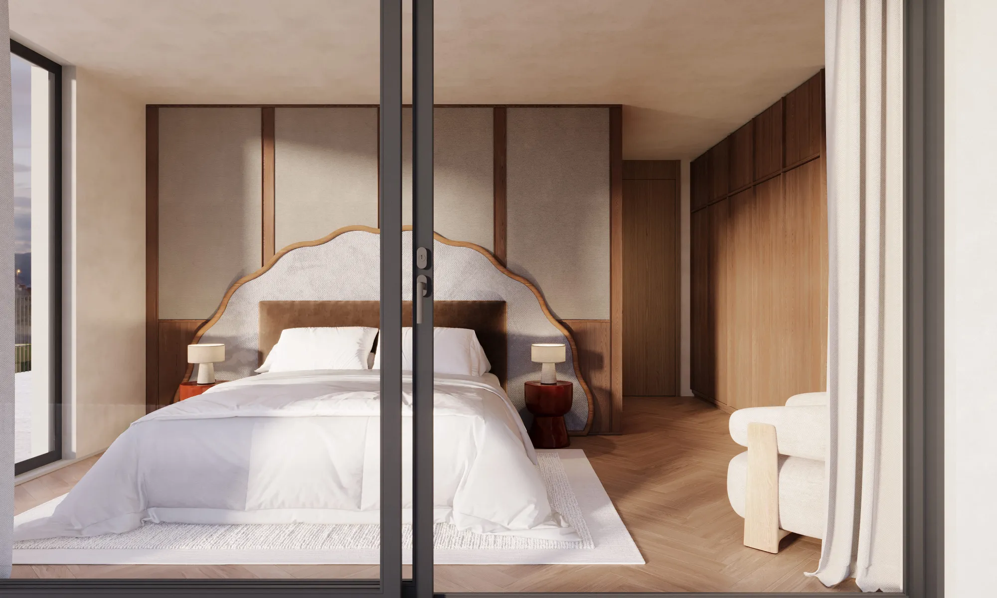 Modern bedroom with a white bed, scalloped headboard, wooden side tables with lamps, and large sliding glass doors.