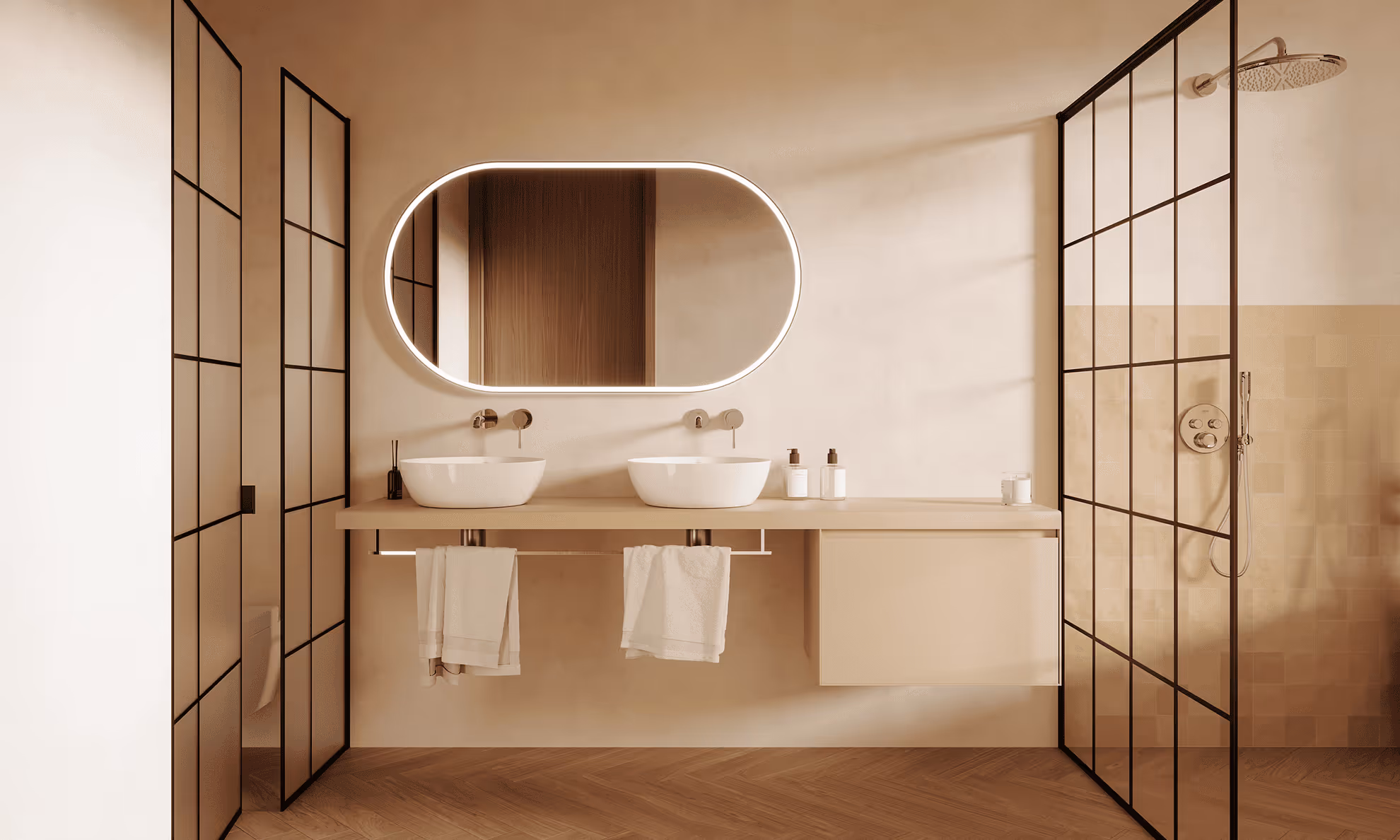 Modern beige bathroom with double white vessel sinks, illuminated oval mirror, and glass shower enclosure with black grid frame.