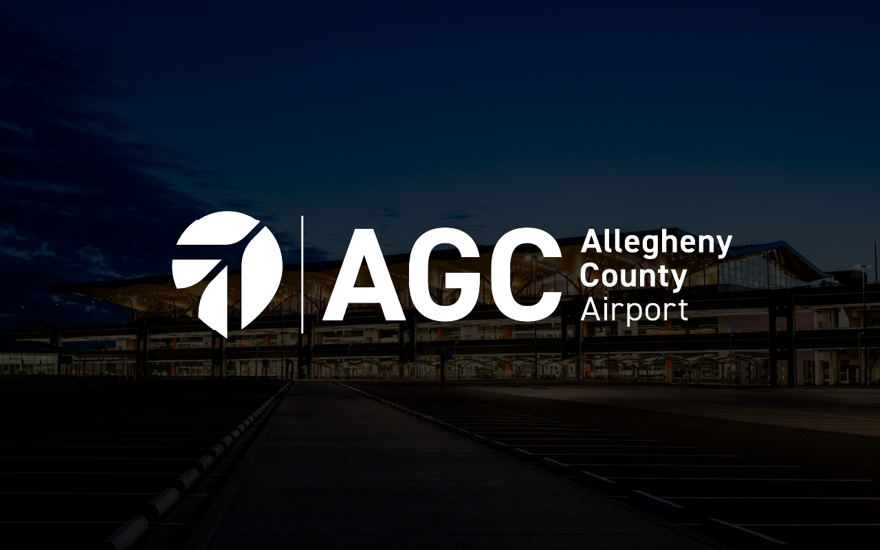 Logo for Allegheny County Airport with stylized A symbol and letters AGC over nighttime airport terminal background.
