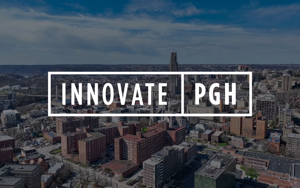 Cityscape of Pittsburgh with a transparent overlay featuring the text 'INNOVATE | PGH' inside white rectangles.