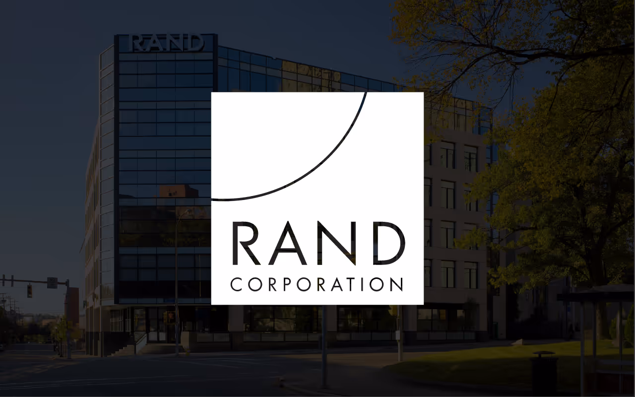 RAND Corporation logo overlay on a photo of a glass office building with the RAND sign on top.