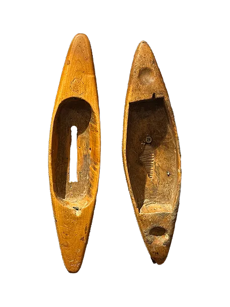 Two vintage wooden weaving shuttles, one showing the hollow center and the other the inner mechanism.