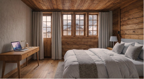 Cozy wooden bedroom with large windows, bed with gray bedding, desk, and laptop.