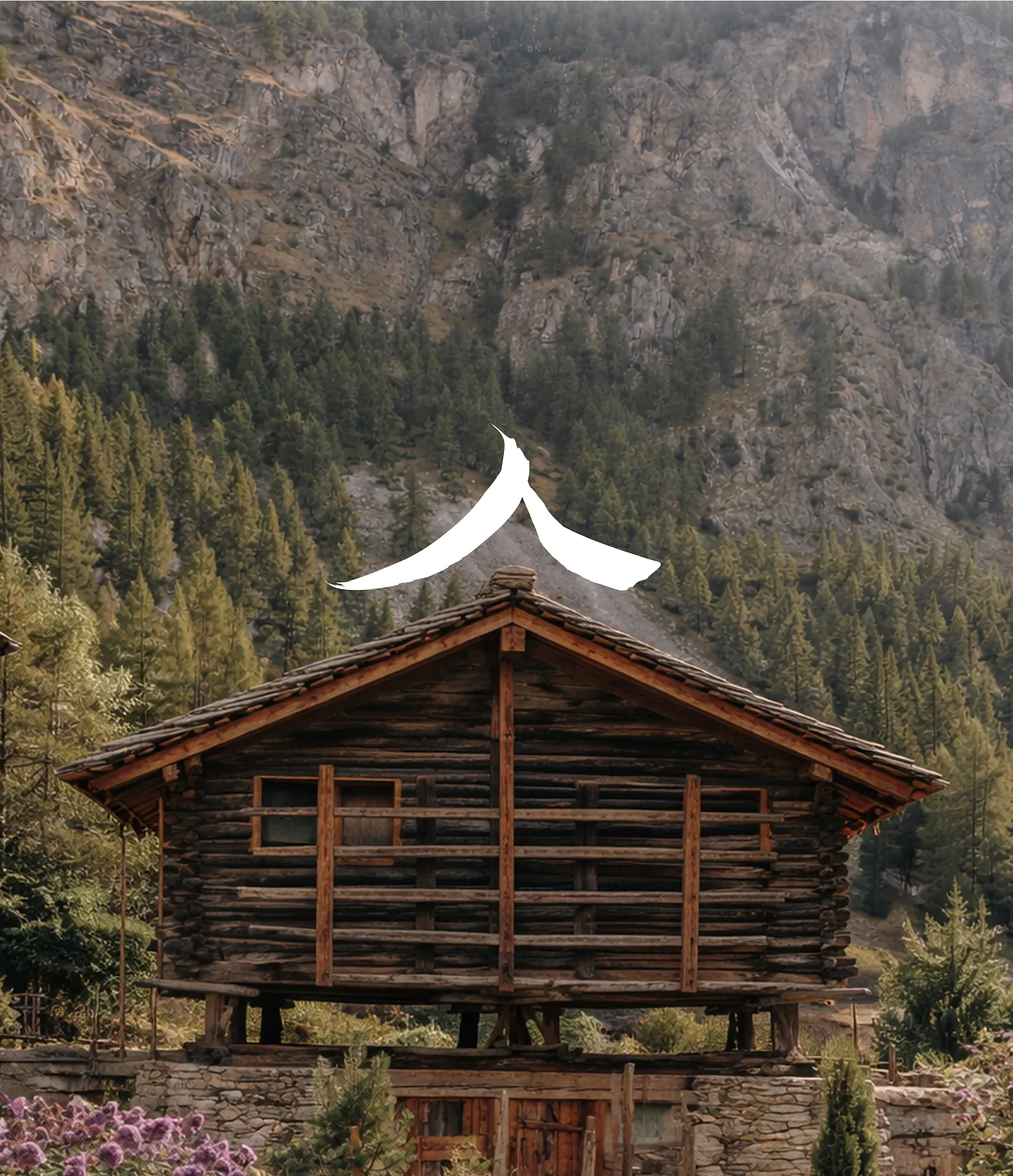 Wooden cabin on stone foundation with mountain and pine forest background.