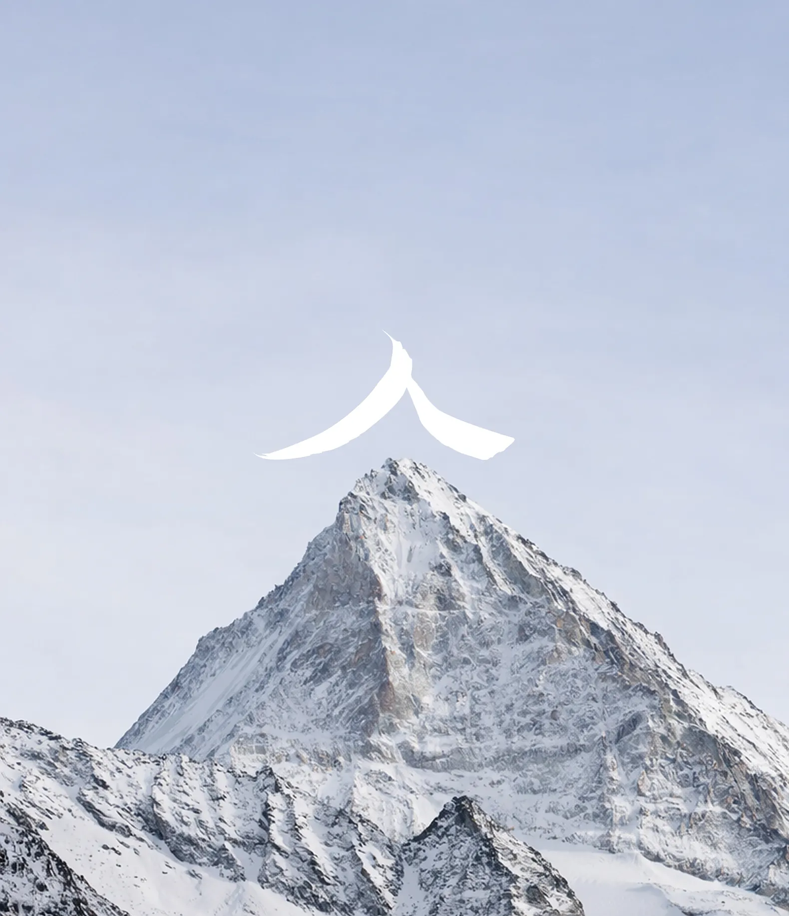 Snow-covered mountain peak under a clear sky with a white abstract shape above the summit.