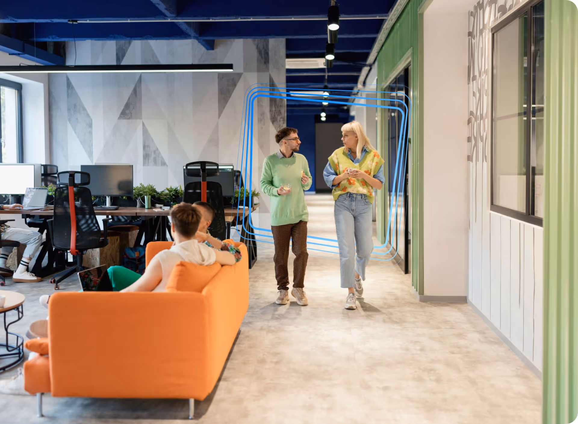 Couple walking through a brightly coloured corporate office