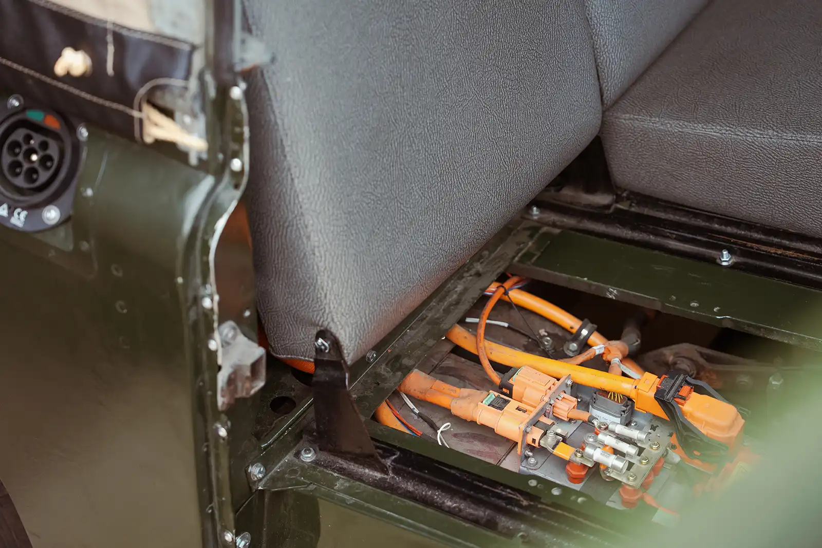 Orange electrical connectors and wiring inside a military vehicle compartment