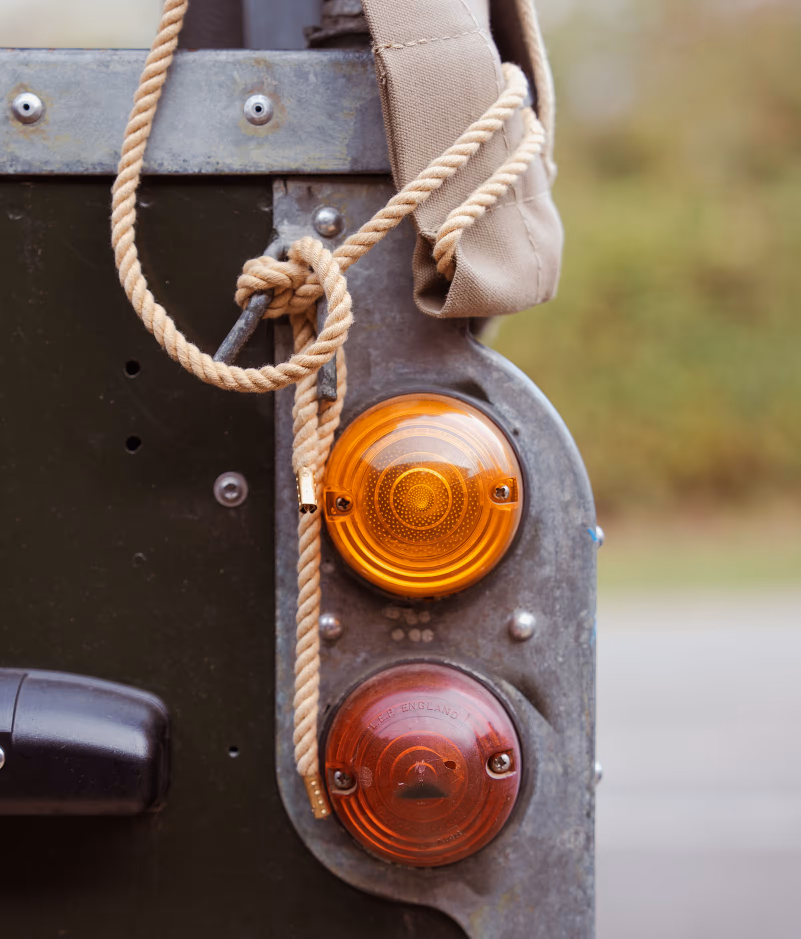 Vintage vehicle tail light with orange and red lenses and twisted rope