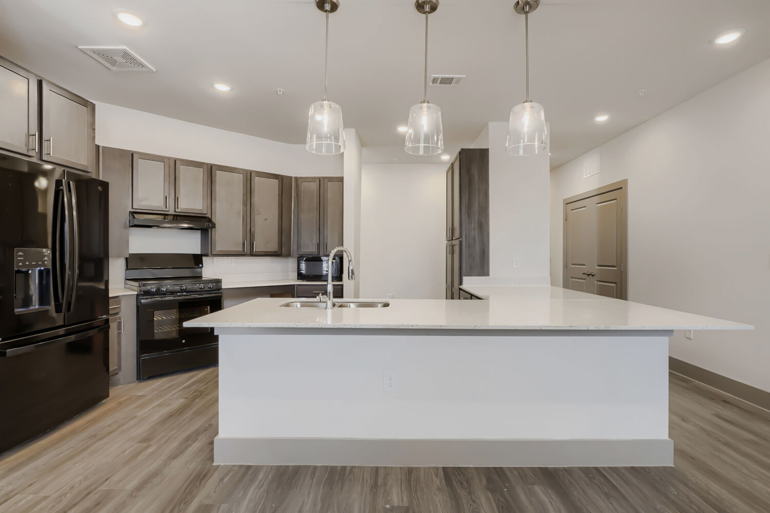 Kitchen with large island and black appliances