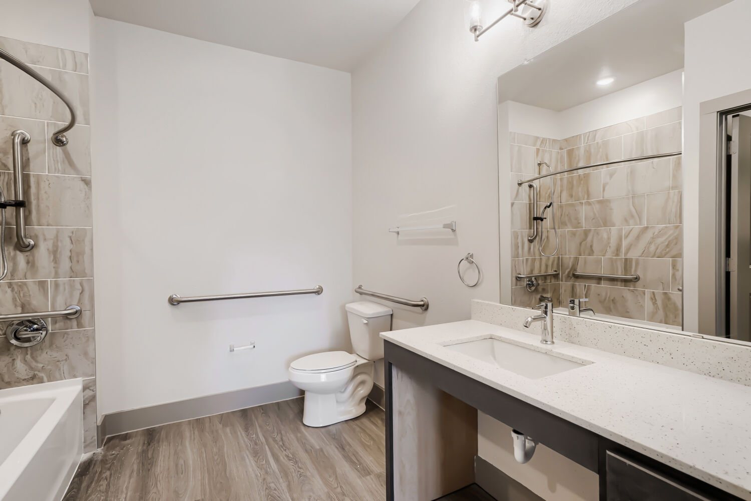 Bathroom with brown vanity and tub