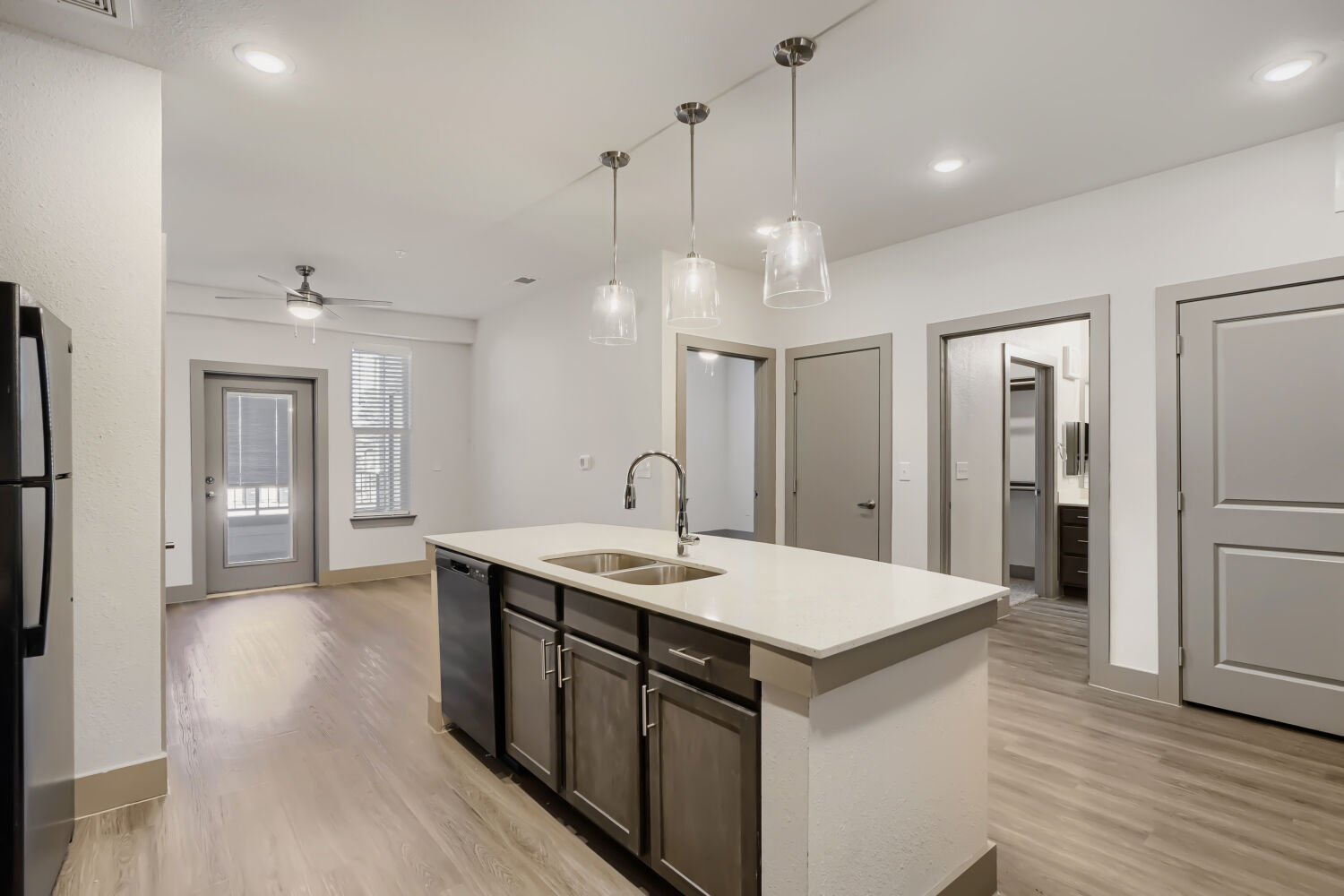 Kitchen with island, brown cabinets and black appliances