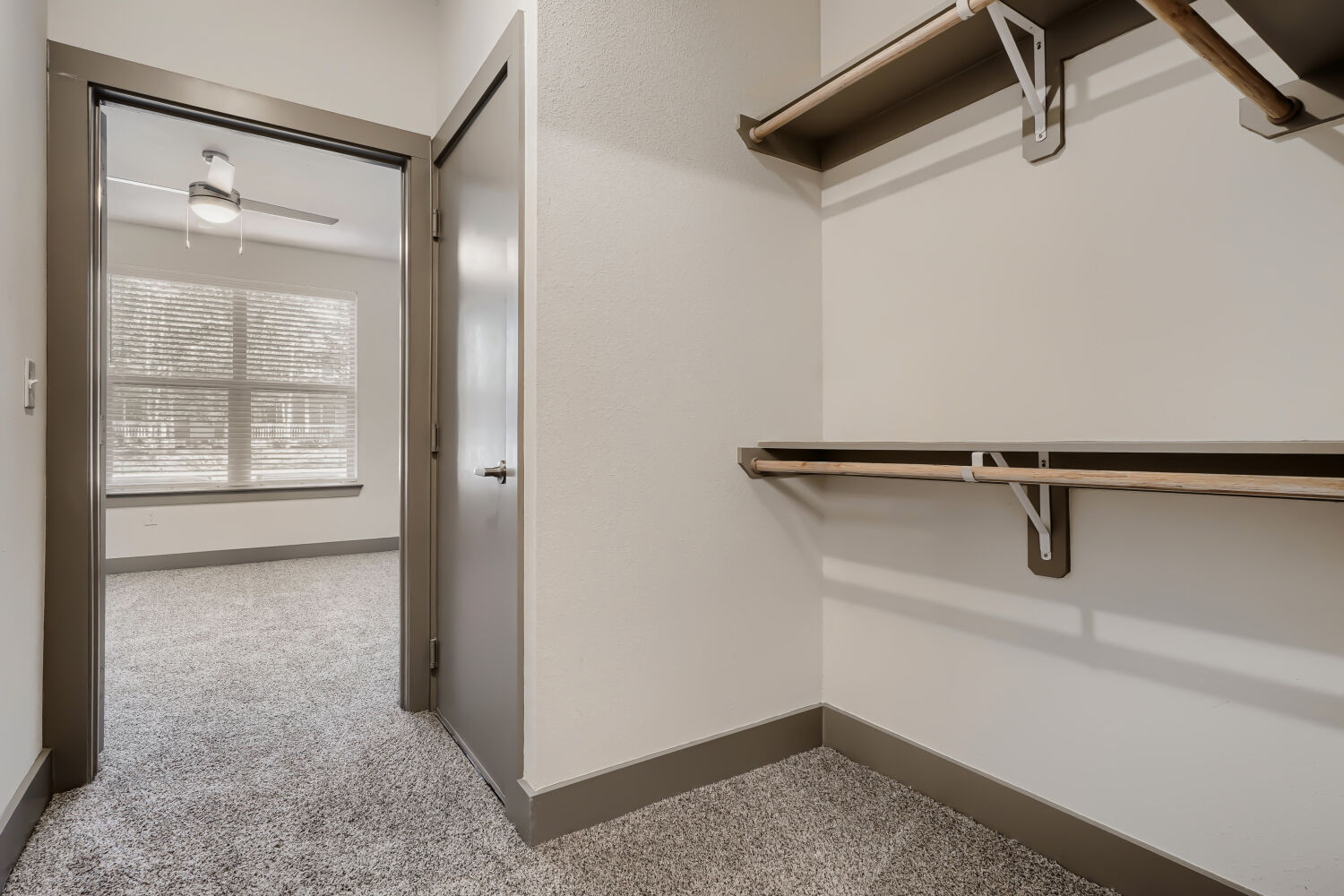 Large walk in closet with view into bedroom
