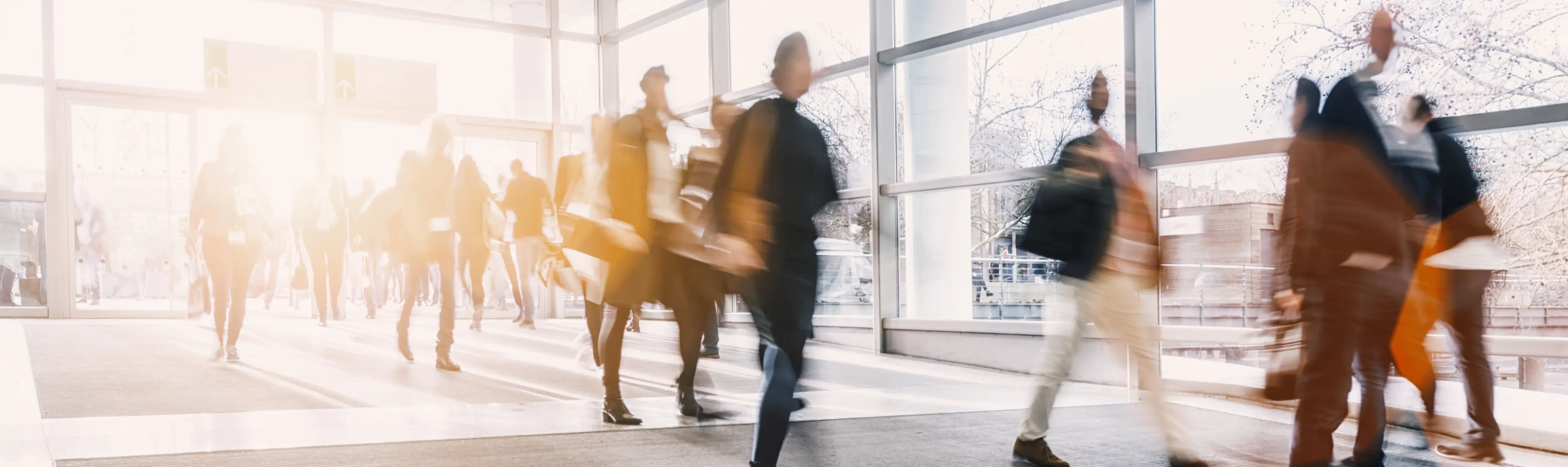 A group of business people walking in a lobby.