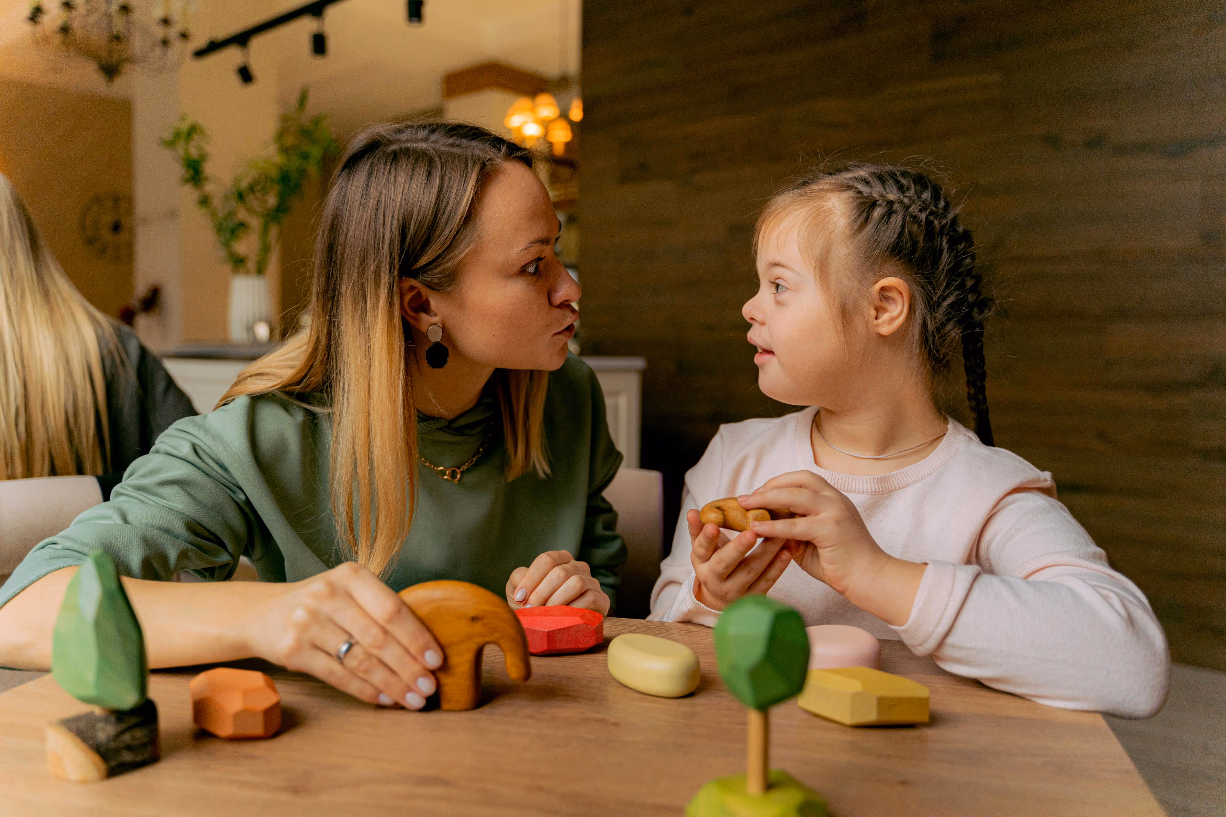 A caregiver and a young child engaging together at home during a care visit