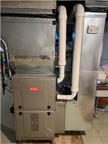 Bryant brand furnace and HVAC unit with connected white PVC piping and metallic ductwork in a basement setting.