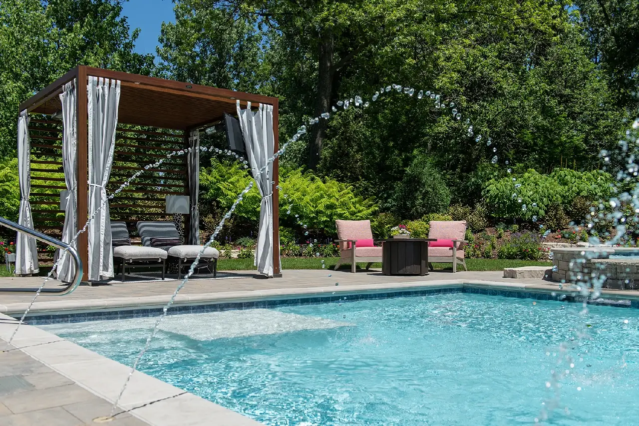 Sprinkler waterfall feature spraying into pool