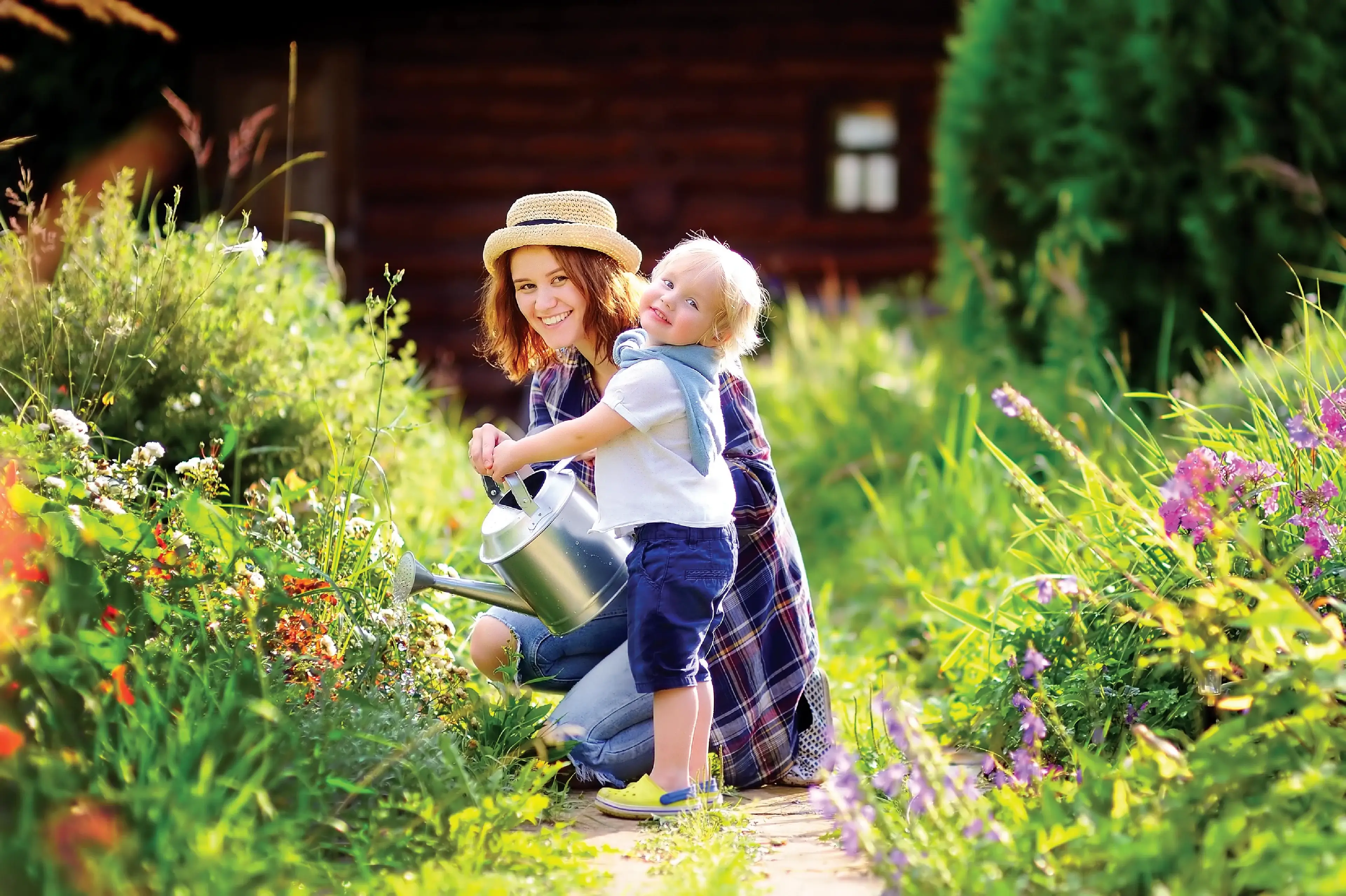 Mom and song enjoying watering the garden