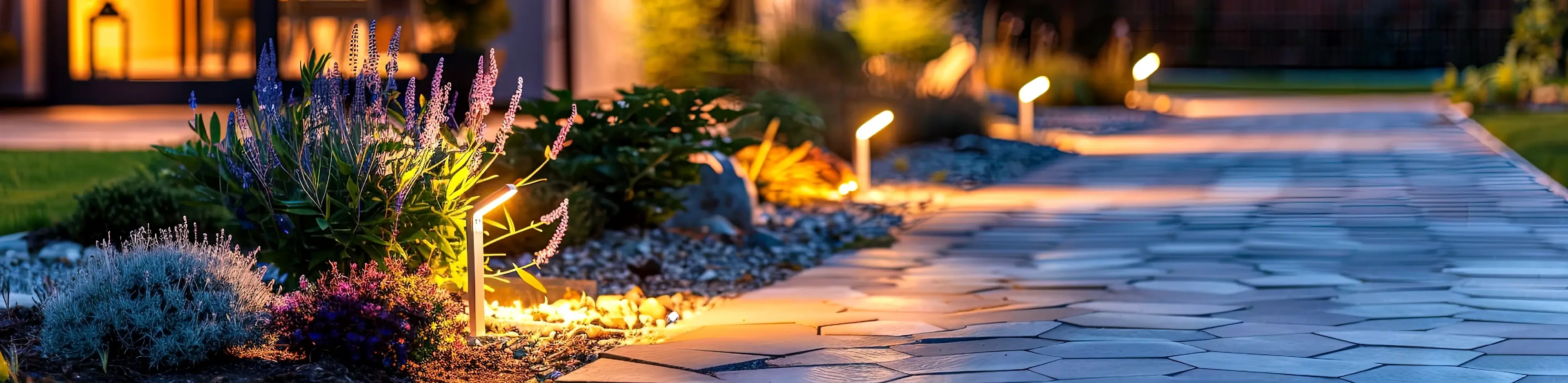 Modern gardening landscaping design details. Illuminated pathway in front of residential house.